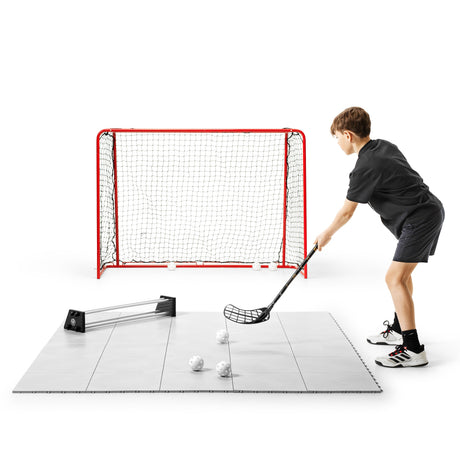 Floorball player receiving a rebound from a passer and shooting at the goal