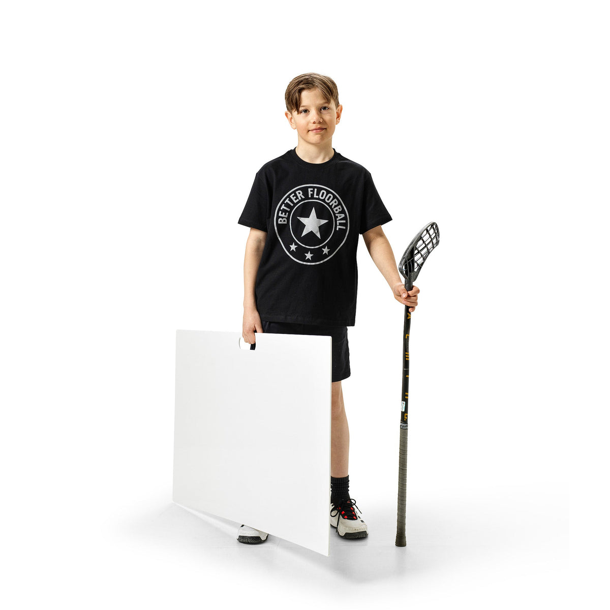 Floorball player practising shots from a shooting pad at home