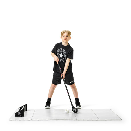 Floorball player doing a light passing session on tiles on a recovery day